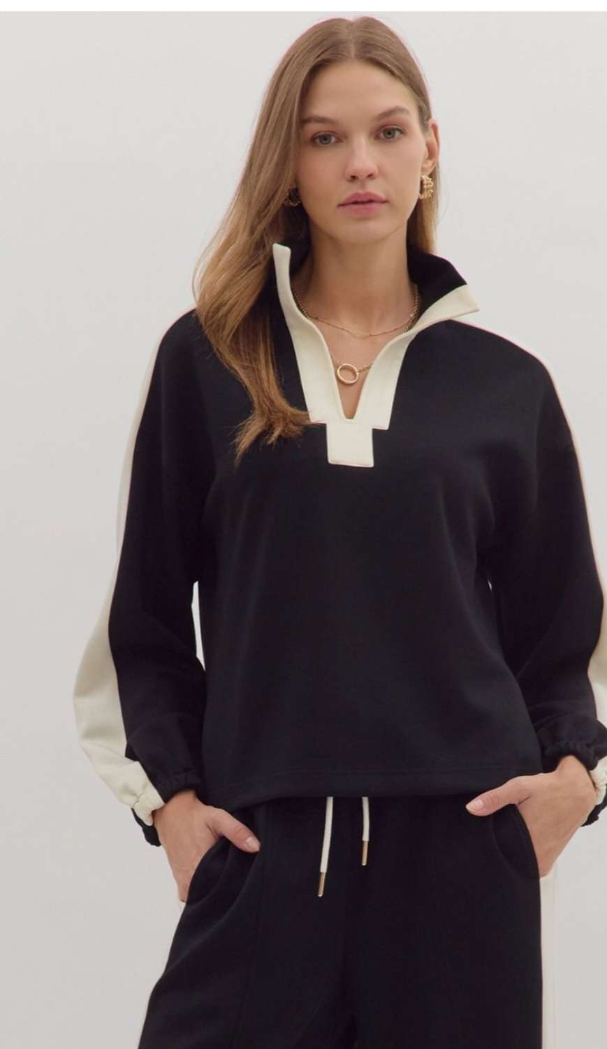 Women's black knit top with white trim detailing