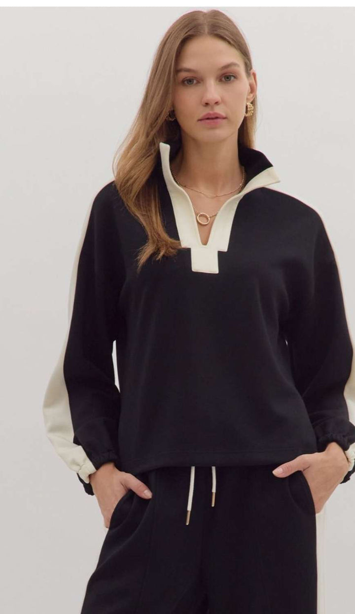 Women's black knit top with white trim detailing