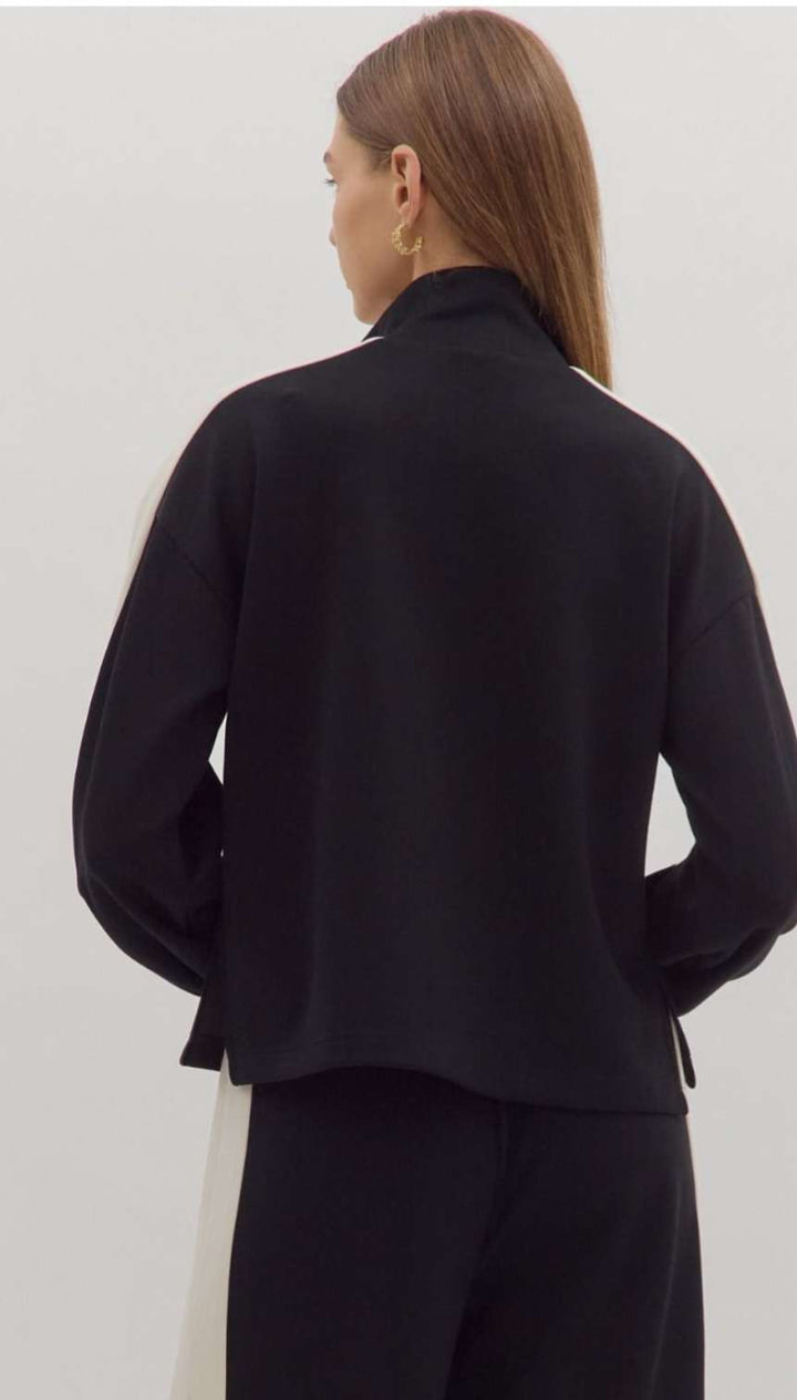 Women's black knit top with white trim detailing