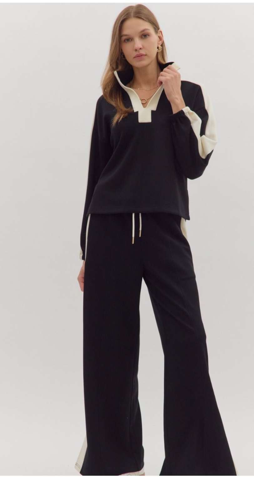 Women's black knit top with white trim detailing