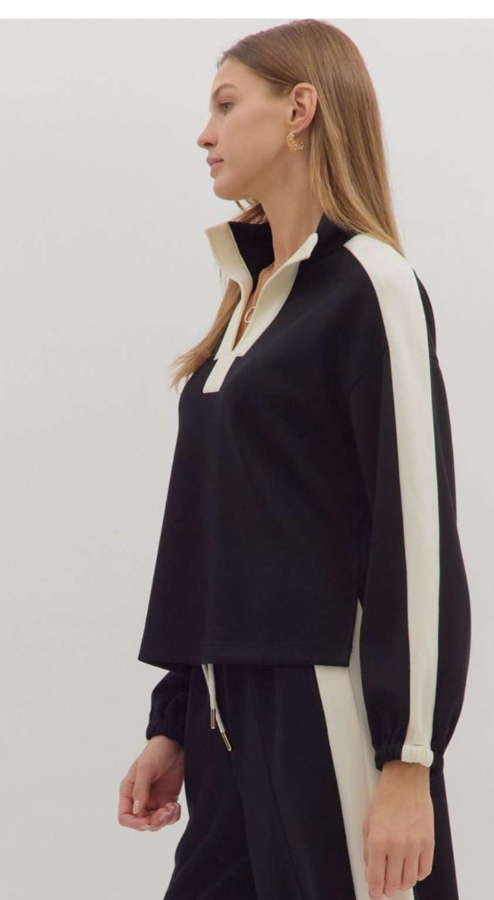 Women's black knit top with white trim detailing