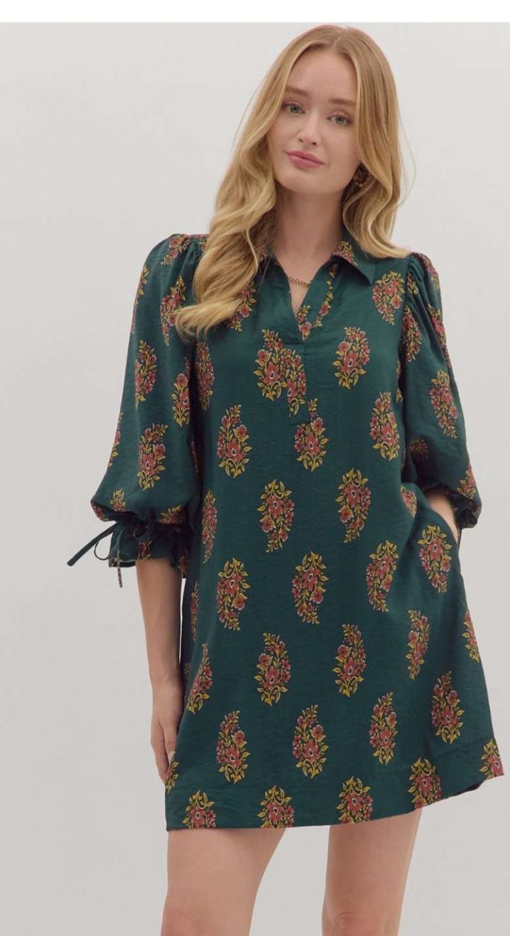 Hunter green floral print short dress with a flowy silhouette and above-the-knee hemline, perfect for casual and semi-formal occasions.