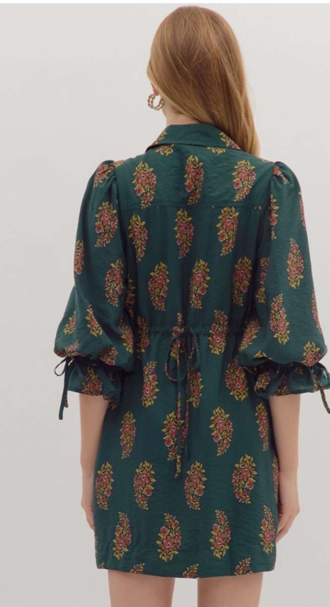 Hunter green floral print short dress with a flowy silhouette and above-the-knee hemline, perfect for casual and semi-formal occasions.