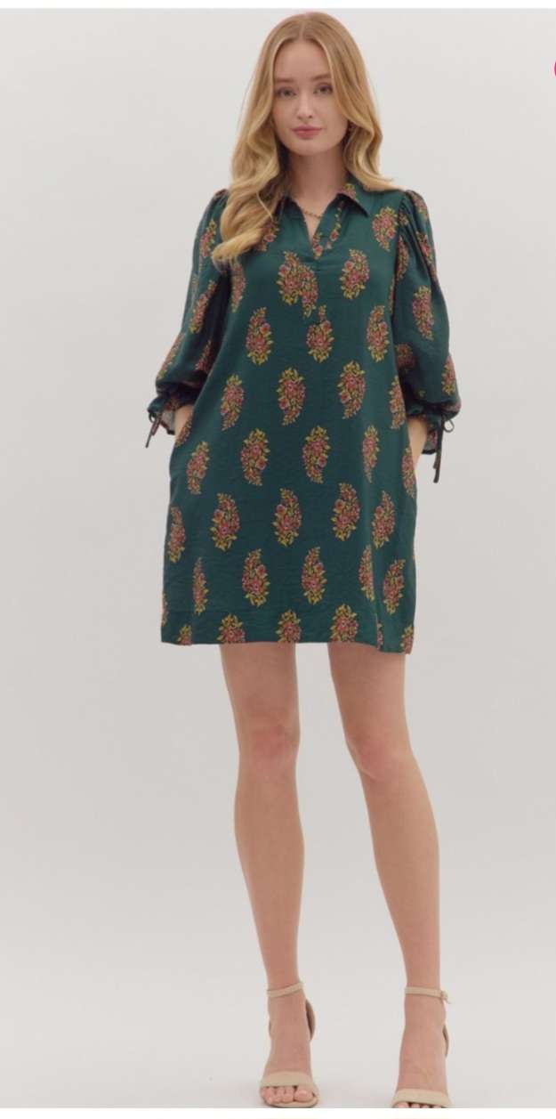 Hunter green floral print short dress with a flowy silhouette and above-the-knee hemline, perfect for casual and semi-formal occasions.