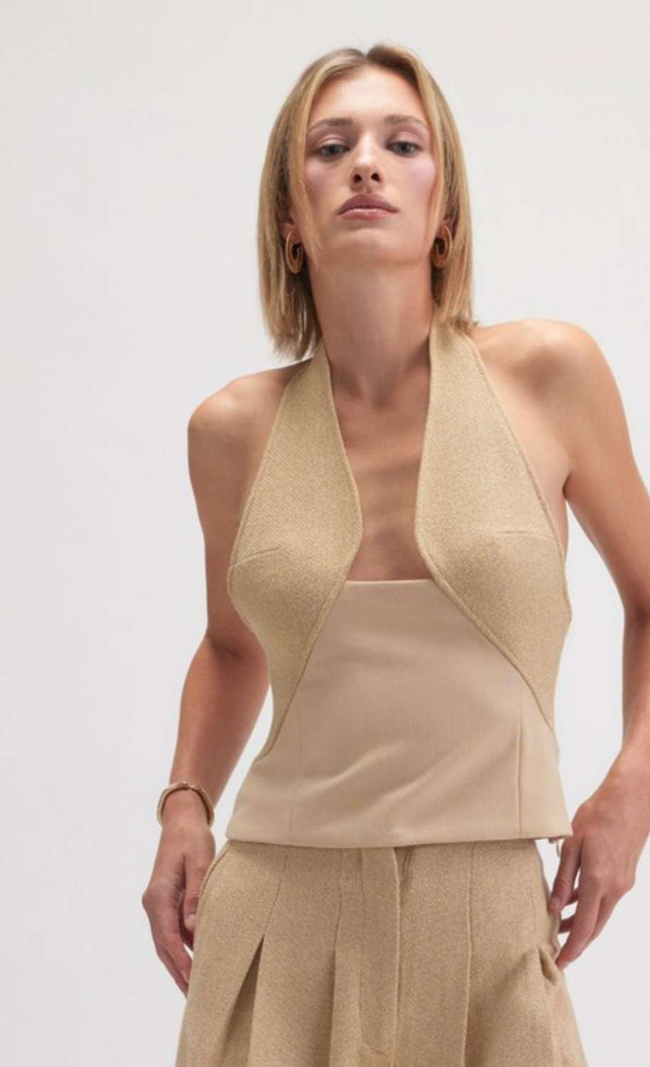 Women's beige halter neck tank with open back and minimalist design, perfect for casual or dressy outfits