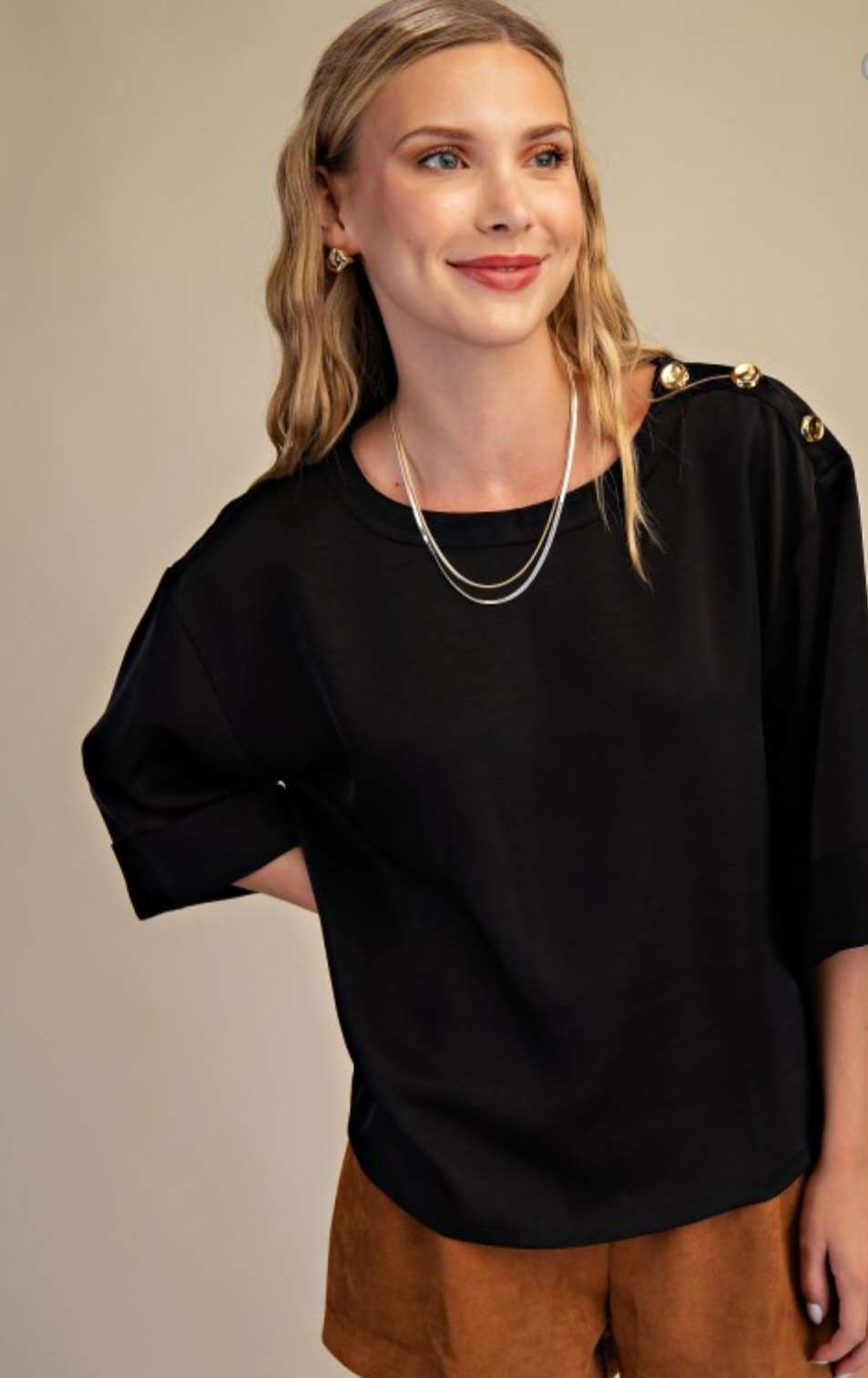 Effortless sophistication in every detail — our Black Shoulder Button Top adds a touch of class to your everyday look.