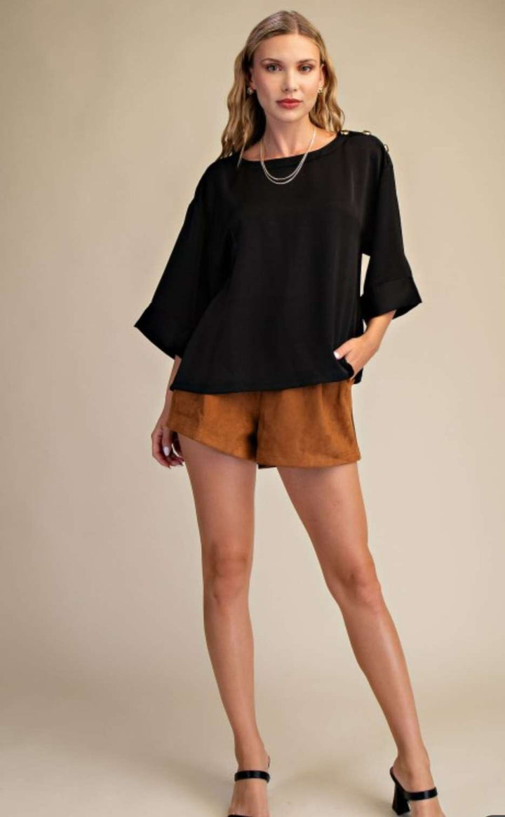 Effortless sophistication in every detail — our Black Shoulder Button Top adds a touch of class to your everyday look.