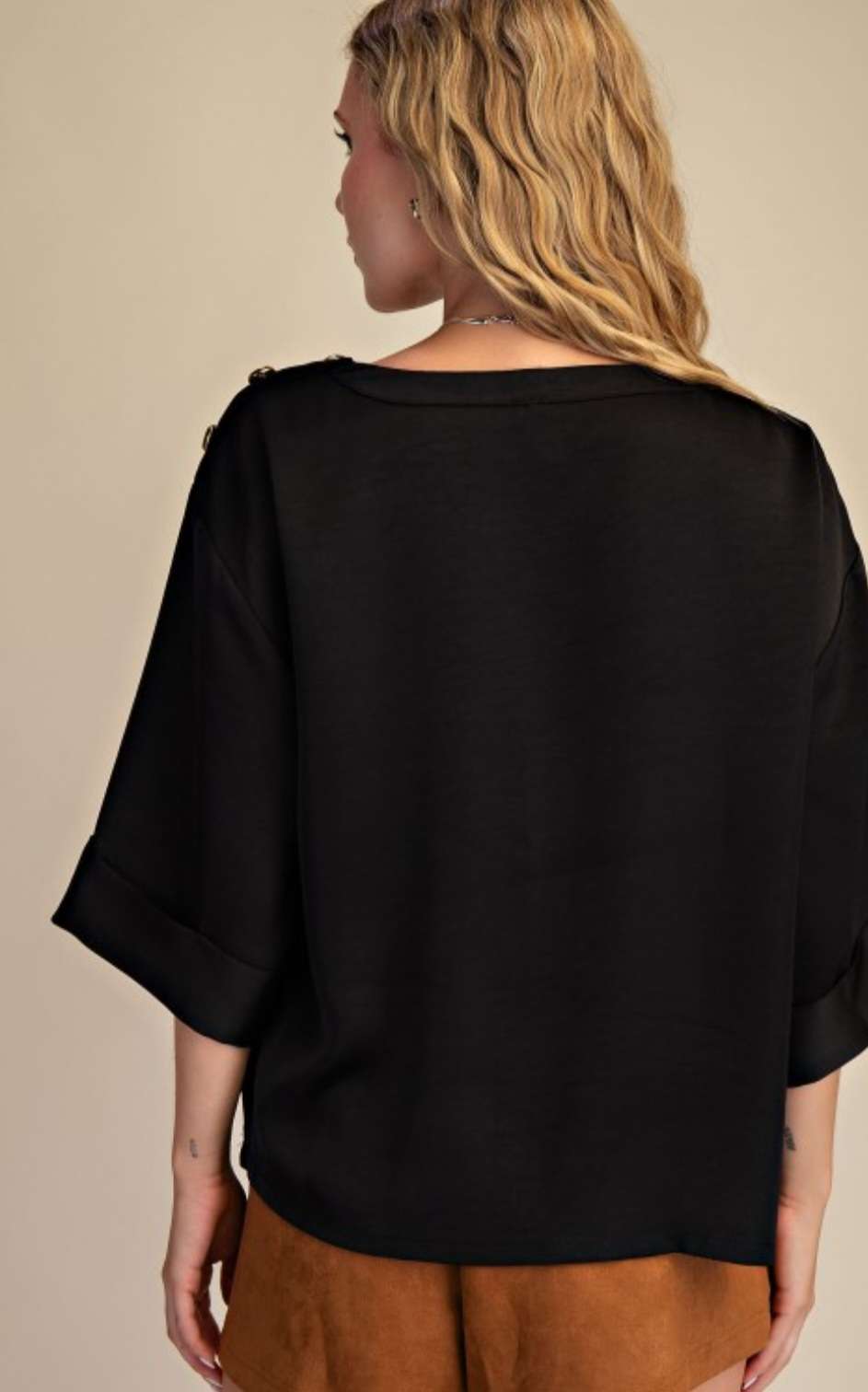 Effortless sophistication in every detail — our Black Shoulder Button Top adds a touch of class to your everyday look.