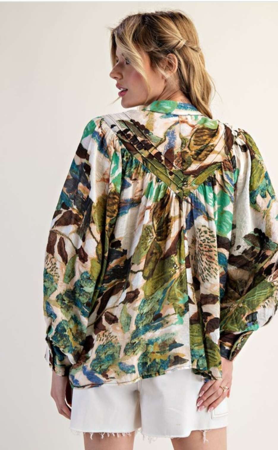 Women’s abstract floral button-down blouse with long sleeves and lightweight fabric.