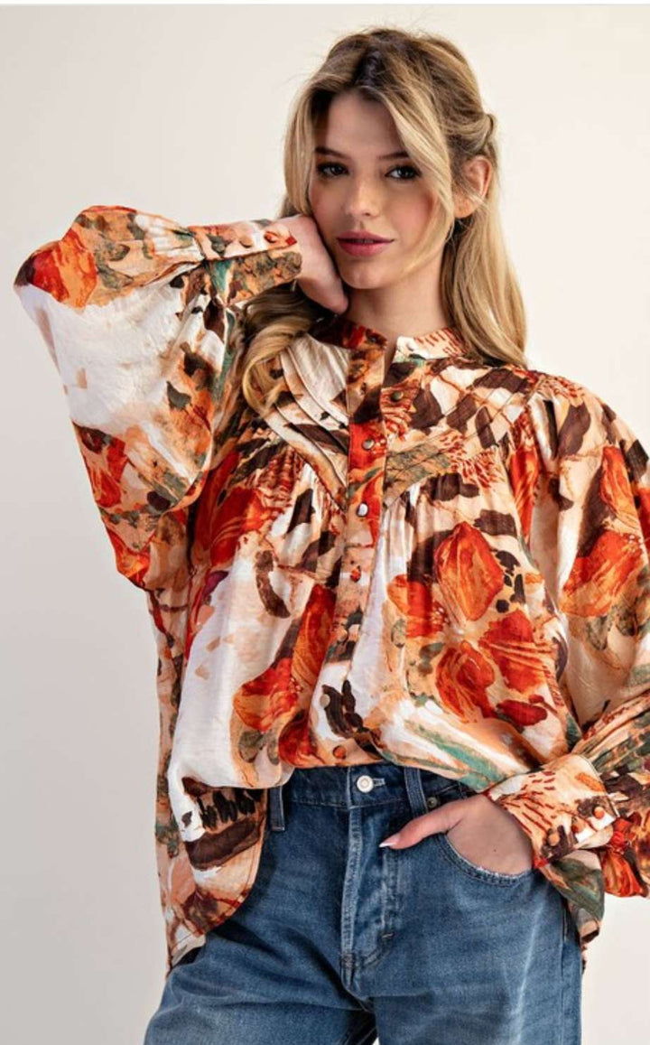 Women’s abstract floral button-down blouse with long sleeves and lightweight fabric.