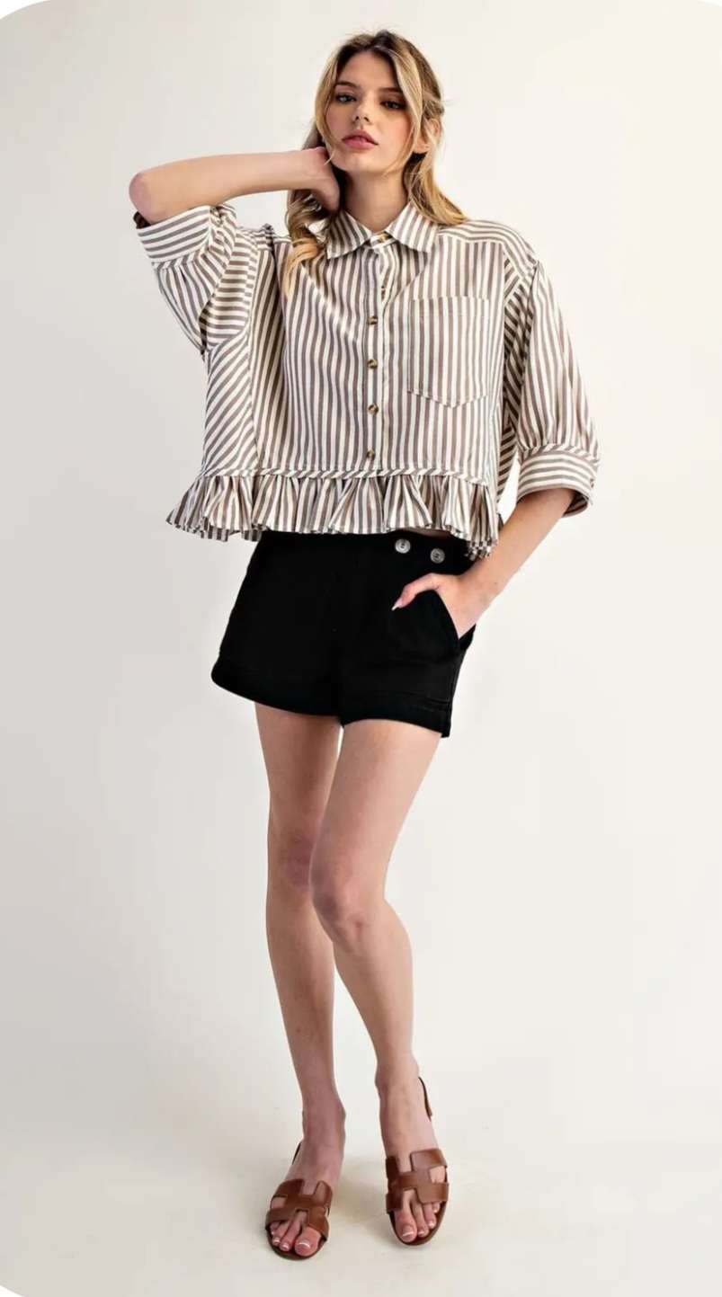 Stylish beige stripe top with ruffle hem paired with jeans for a modern, feminine look.