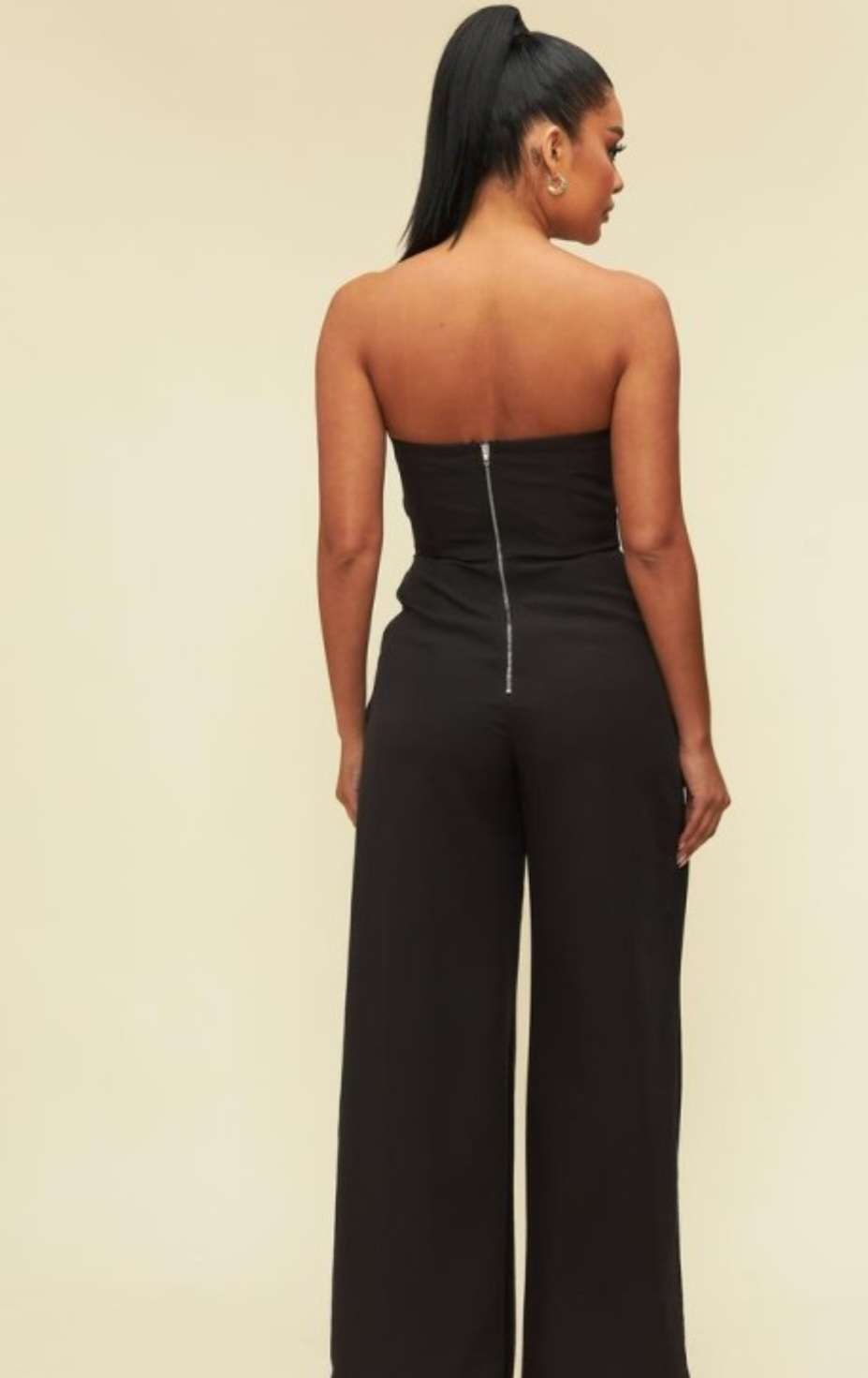 Elegant black strapless jumpsuit featuring thigh-high slit and tailored fit