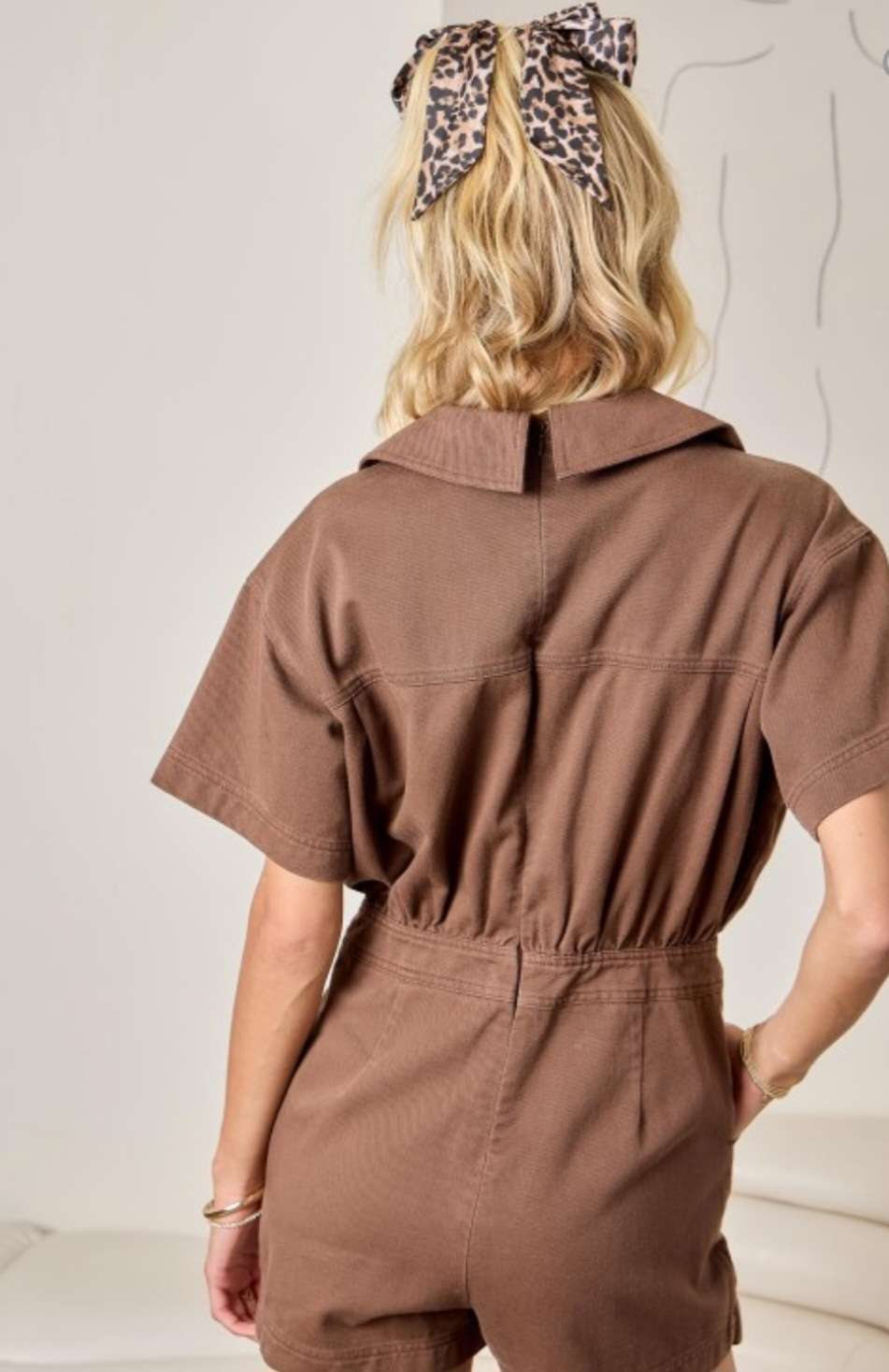 Women's brown denim skort romper with back zipper closure and skirt overlay