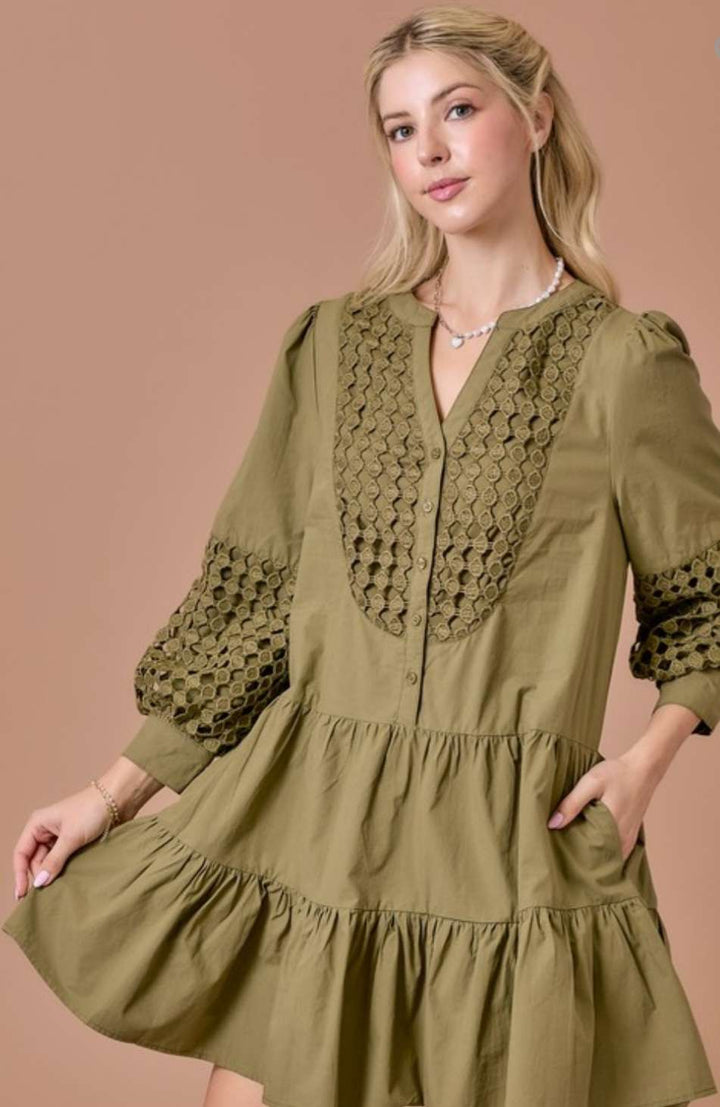 Olive eyelet tiered short dress with 3/4 sleeves, featuring delicate eyelet embroidery, flowy tiered skirt, and a flattering relaxed fit.