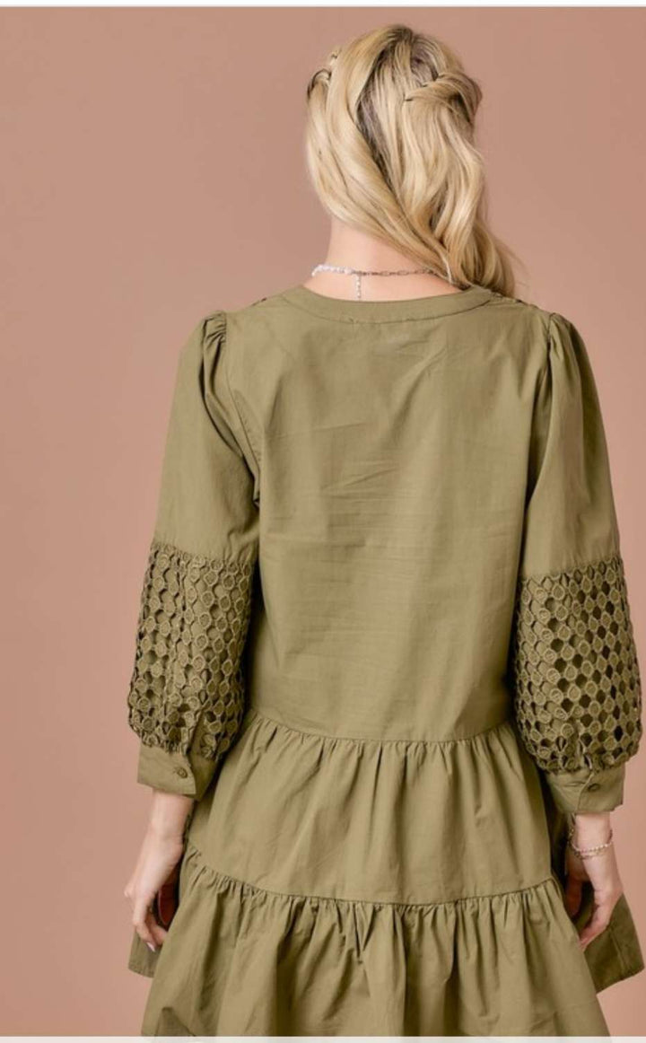 Olive eyelet tiered short dress with 3/4 sleeves, featuring delicate eyelet embroidery, flowy tiered skirt, and a flattering relaxed fit