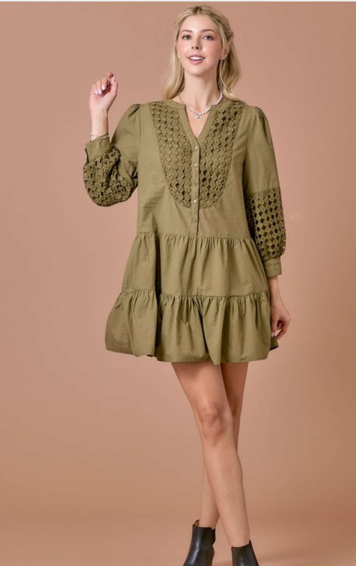 Olive eyelet tiered short dress with 3/4 sleeves, featuring delicate eyelet embroidery, flowy tiered skirt, and a flattering relaxed fit.