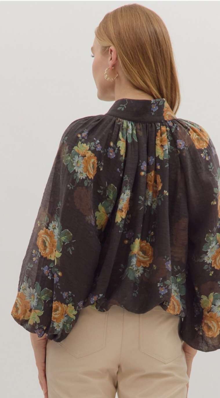 Women’s floral print puff sleeve top with V-neckline and bubble hem in lightweight fabric.