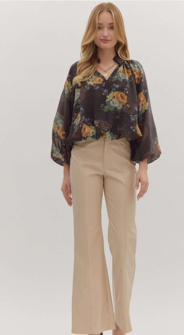 Women’s floral print puff sleeve top with V-neckline and bubble hem in lightweight fabric.