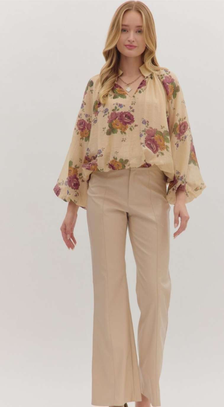 Women’s floral print puff sleeve top with V-neckline and bubble hem in lightweight fabric.