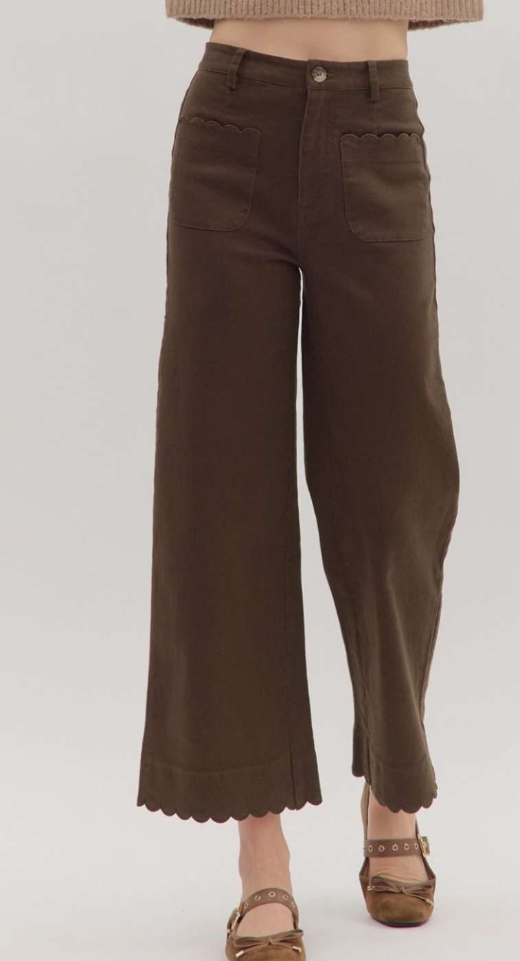 Women’s brown jeans with scallop trim hem and front pockets, high-waisted relaxed fit.