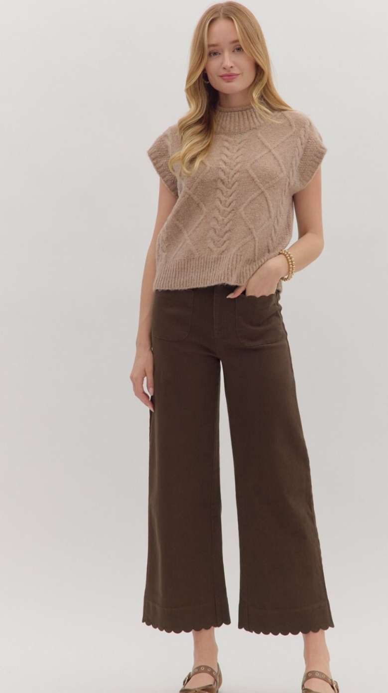 Women’s brown jeans with scallop trim hem and front pockets, high-waisted relaxed fit.