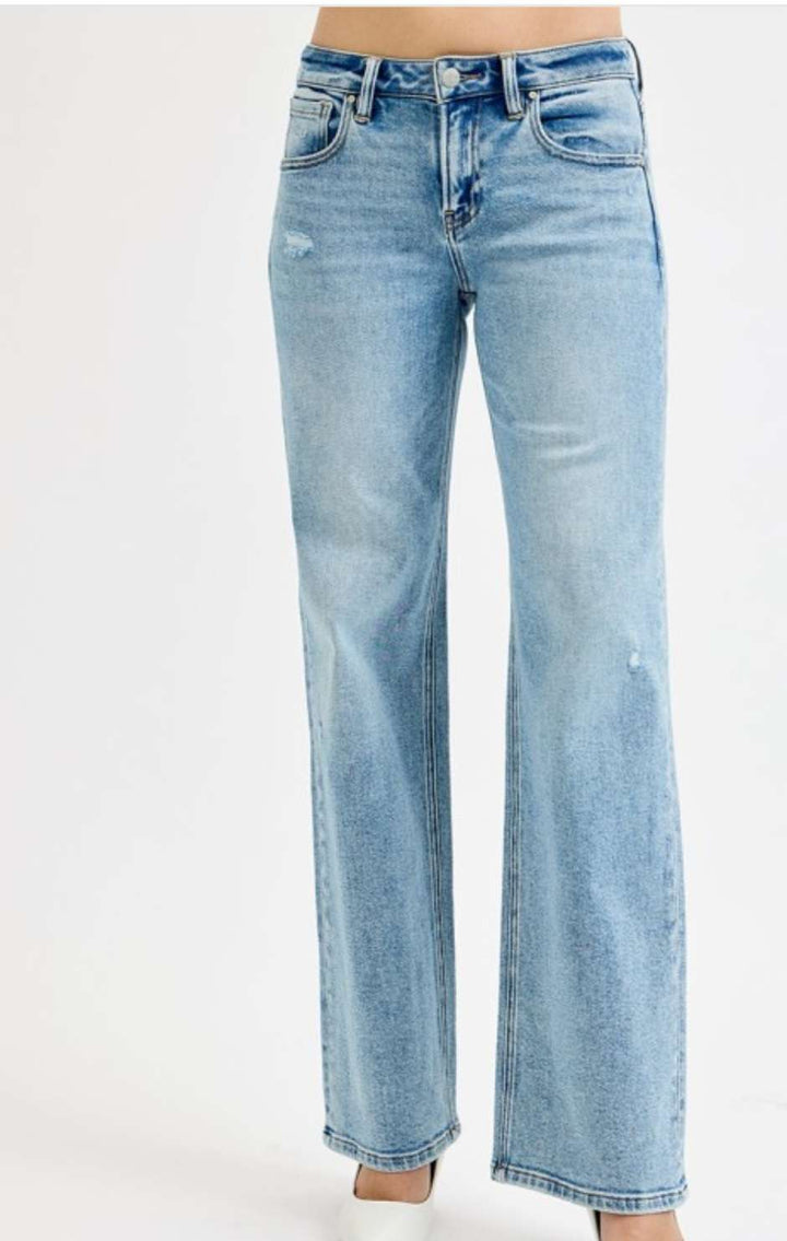 Low rise wide leg jeans for women in light blue denim, featuring relaxed fit and casual street style look.