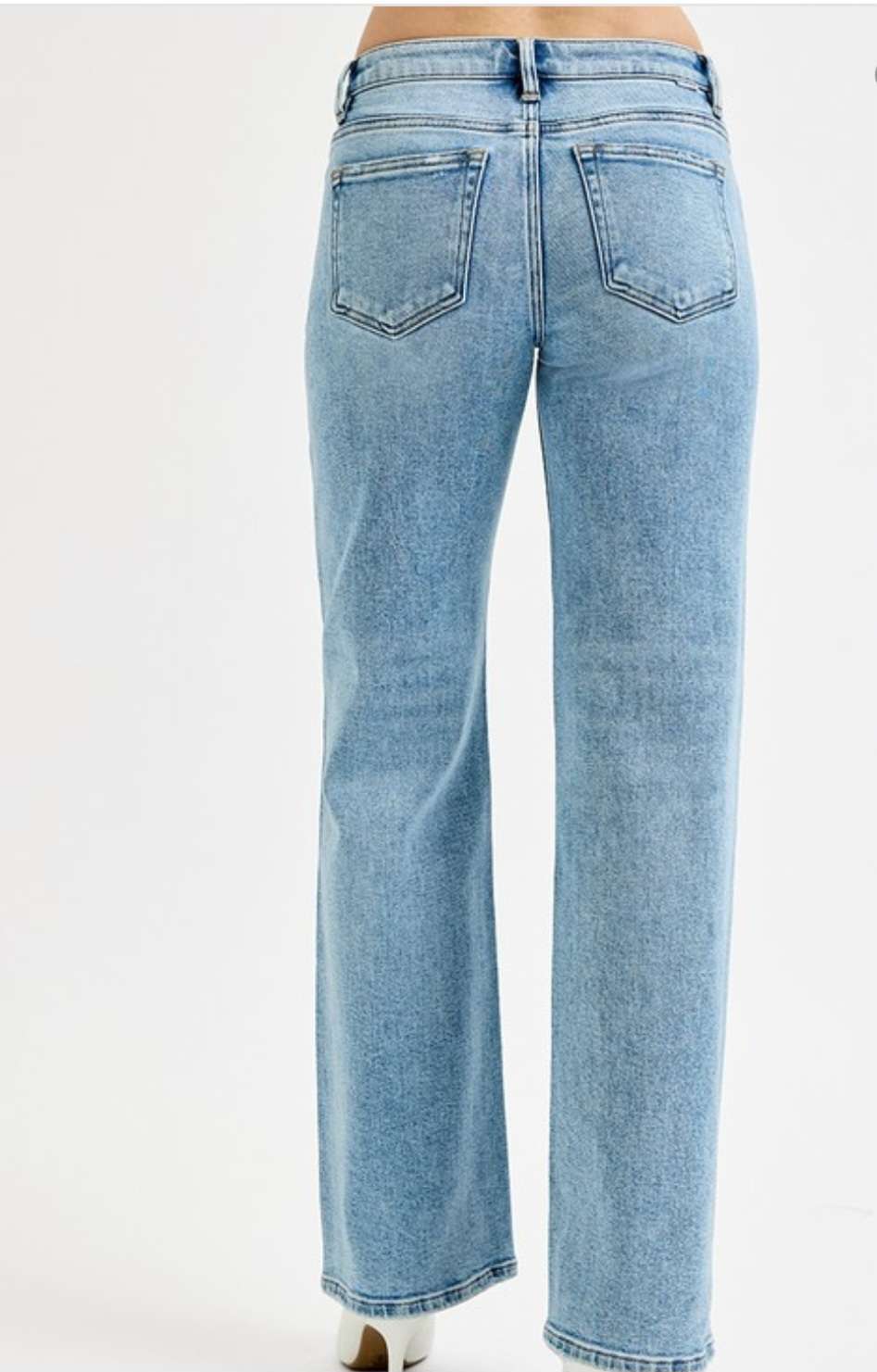 Low rise wide leg jeans for women in light blue denim, featuring relaxed fit and casual street style look.