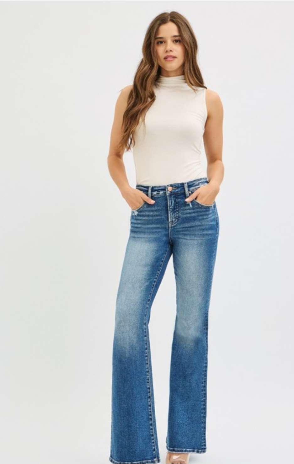 High-rise flare jeans in medium wash denim with classic five-pocket design and flattering fit.