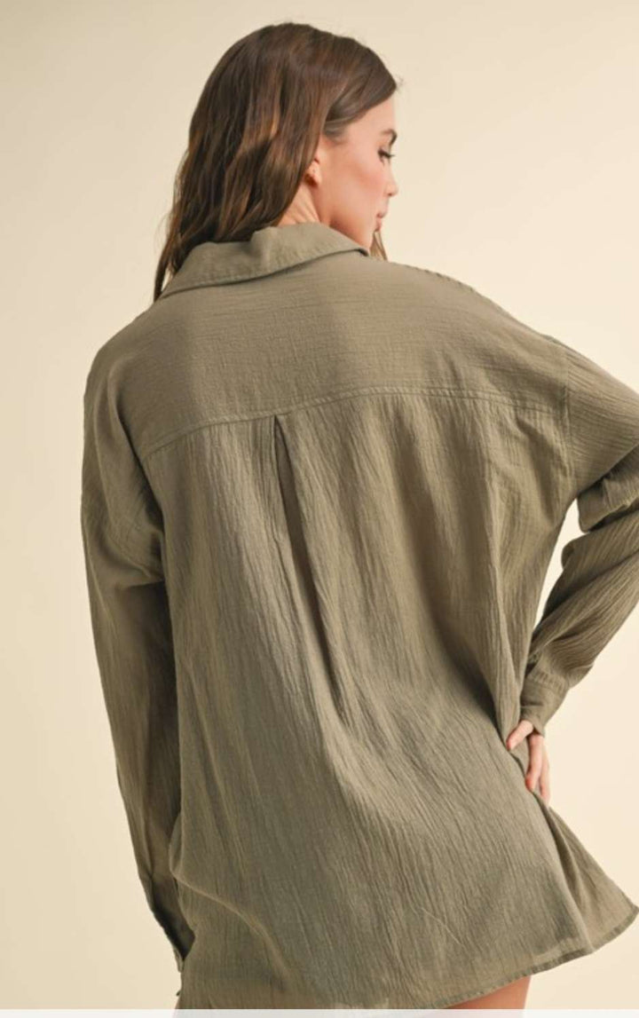 Olive green button-up top with classic collar and versatile long sleeves for everyday wear.