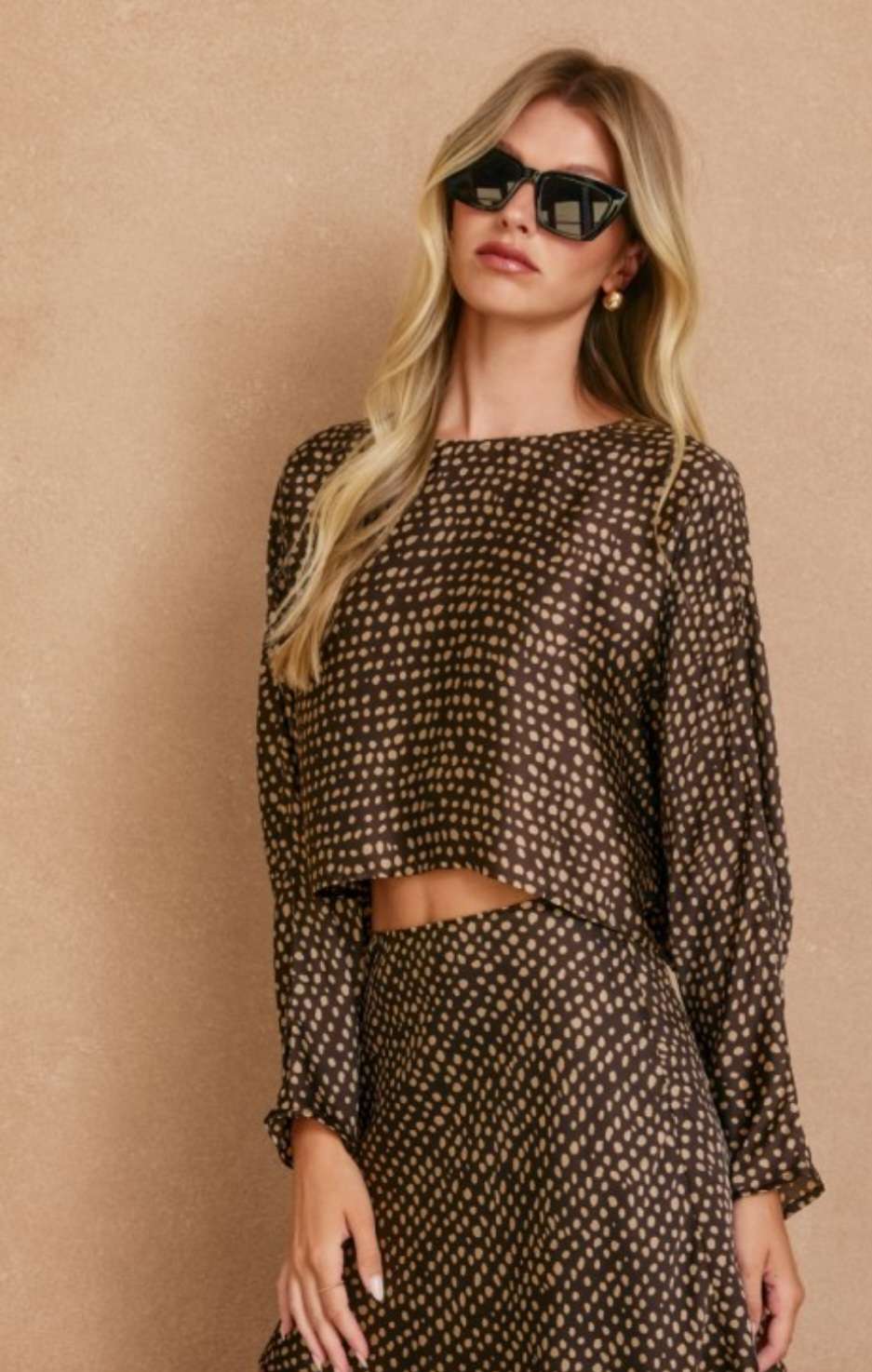 Women’s brown printed boat neck top with relaxed fit and stylish pattern