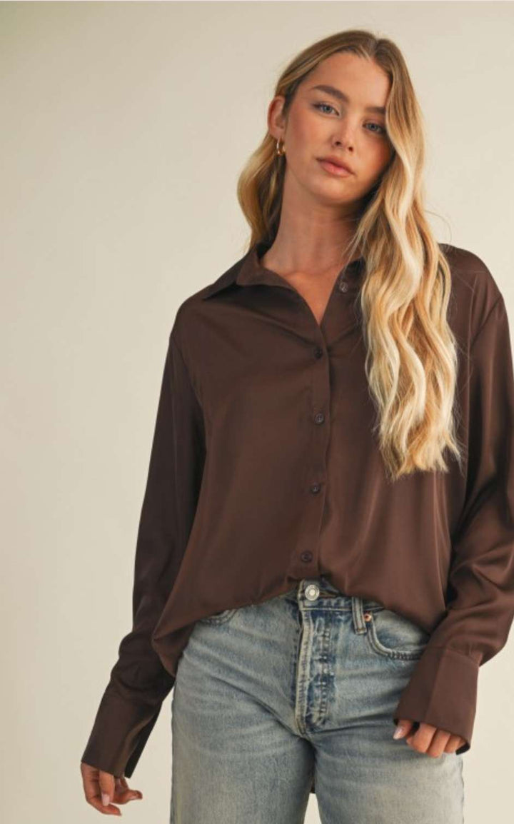 Women's brown silky button-up top with soft satin finish and elegant collar.