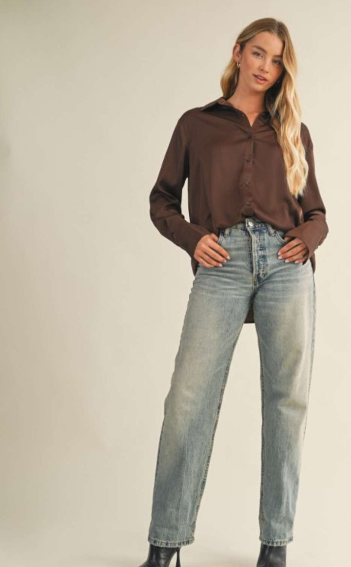 Women's brown silky button-up top with soft satin finish and elegant collar.