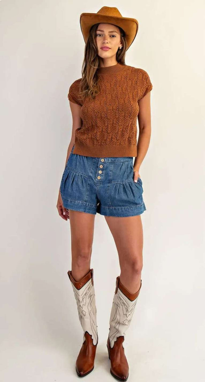 Brown sleeveless sweater featuring a mock neck and soft knit fabric