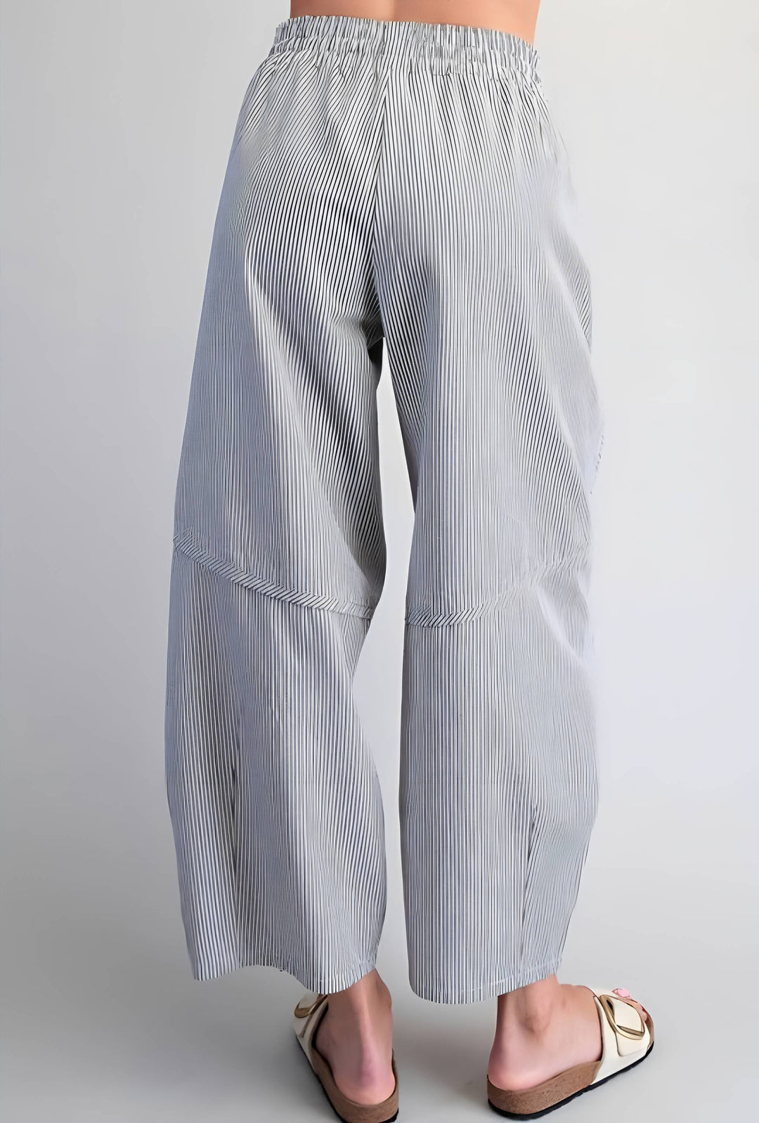 Light blue and white striped pants on a plain background