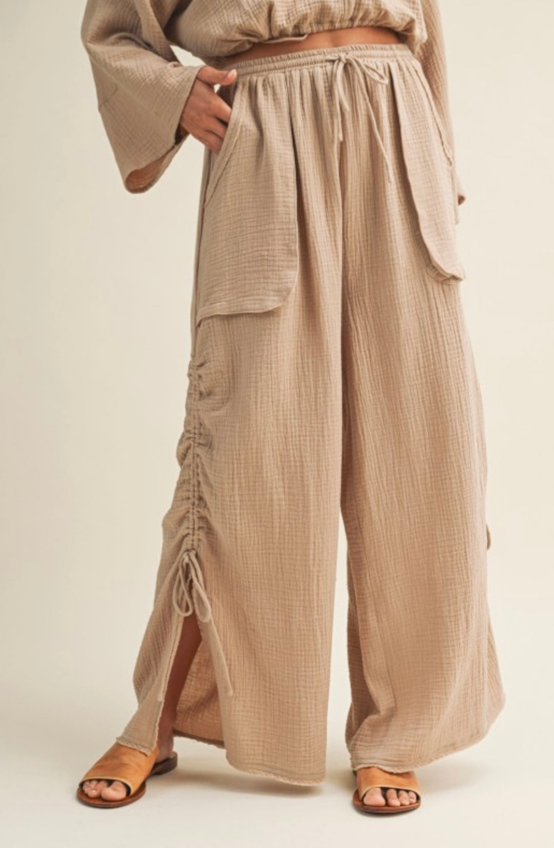 Girl standing in beige baggy pant 