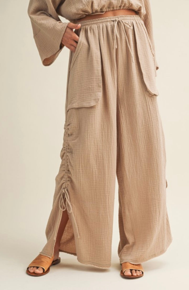 Girl standing in beige baggy pant 