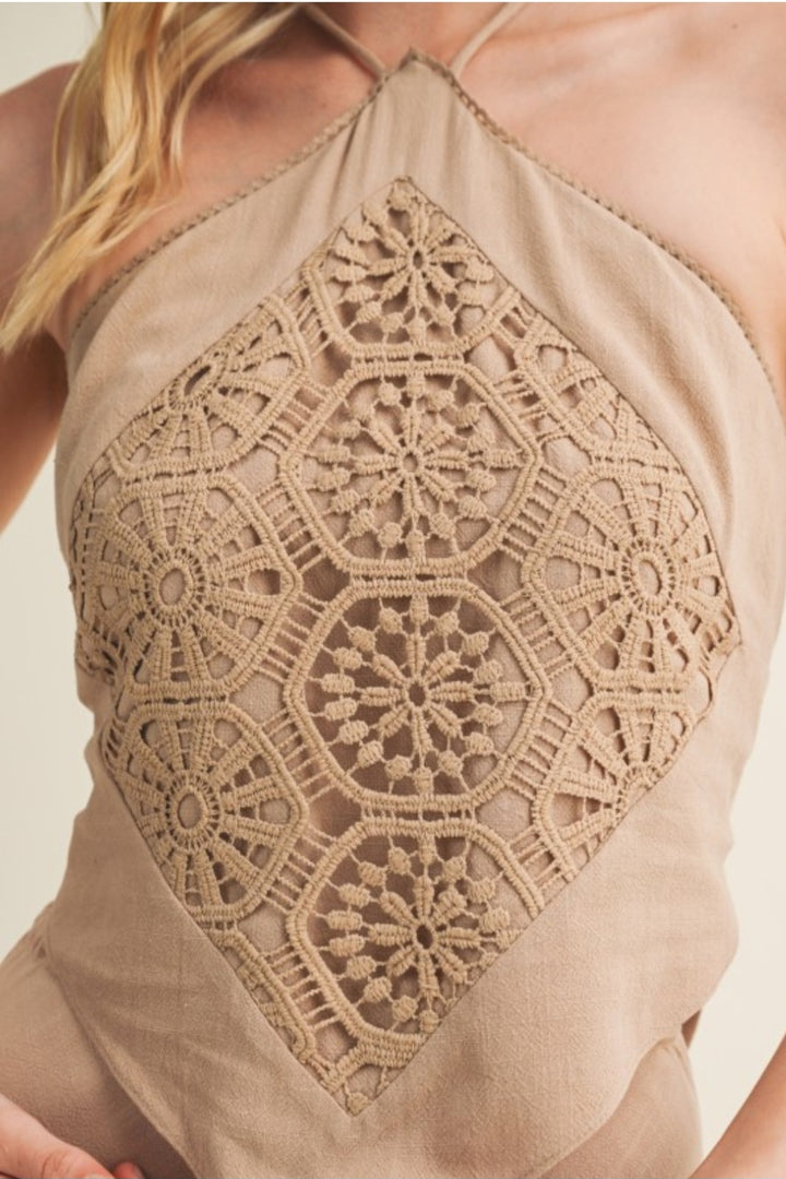 Beige lace top with geometric pattern on a plain background