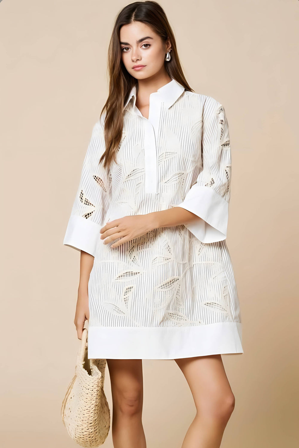 Woman wearing a white lace dress with a beige background