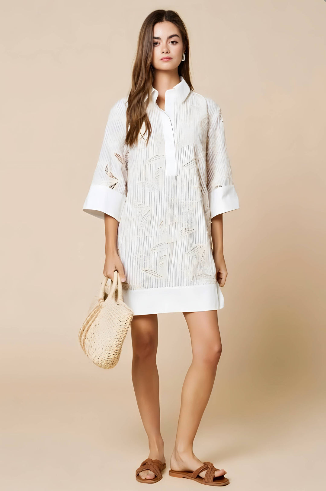 Woman wearing a white dress holding a straw bag against a beige background