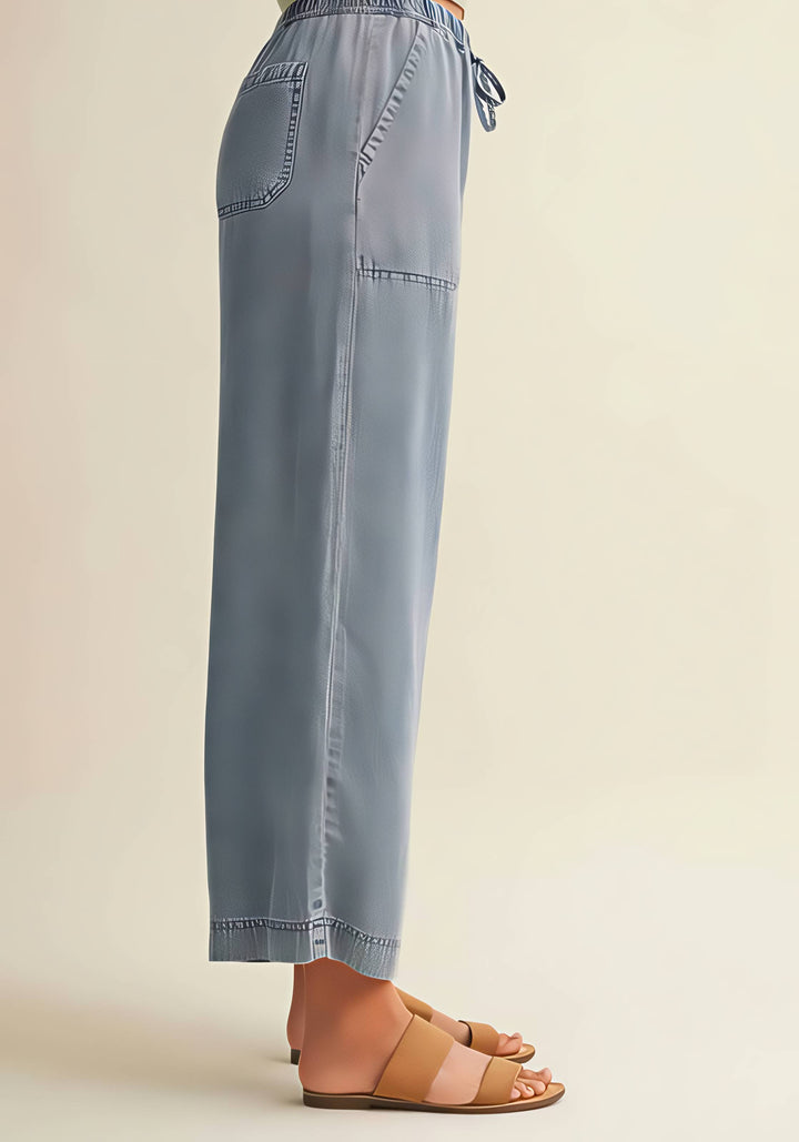 Light blue pants worn by a person on a beige background