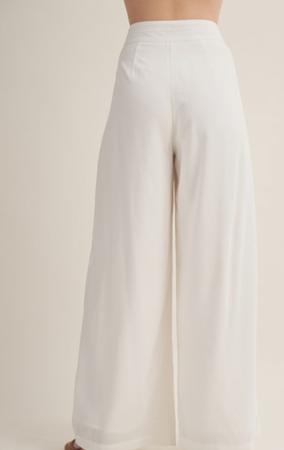 White wide-leg pants on a plain background