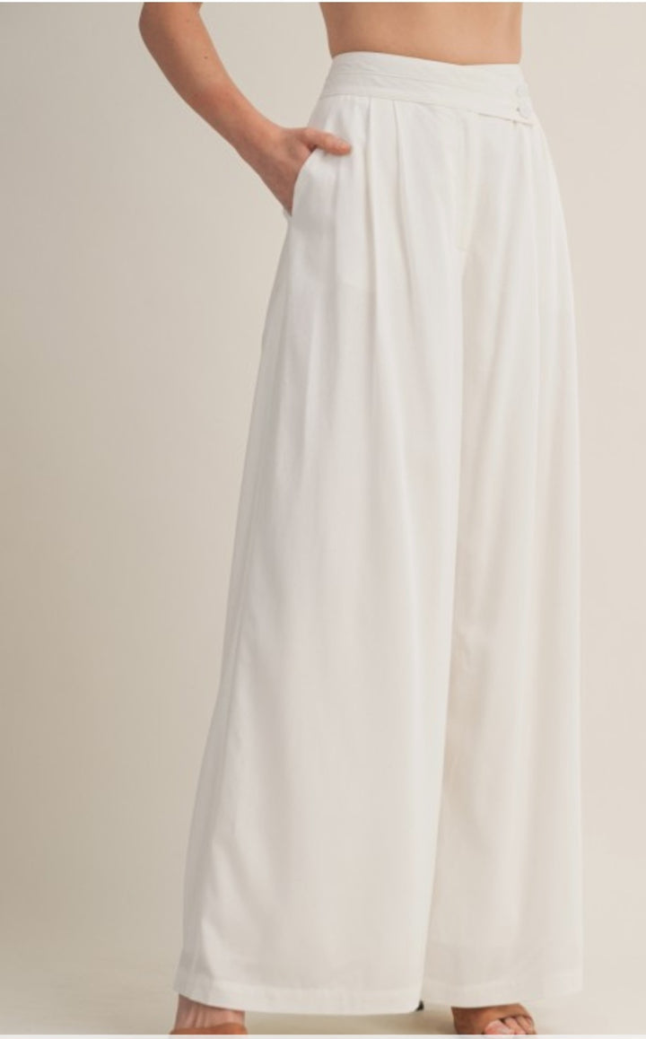 White wide-leg pants worn by a person on a plain background