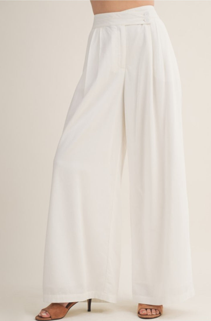 White wide-leg pants on a plain background