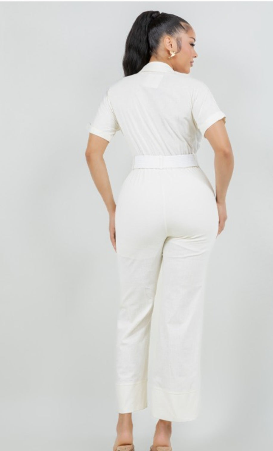 Person wearing a white outfit on a plain background