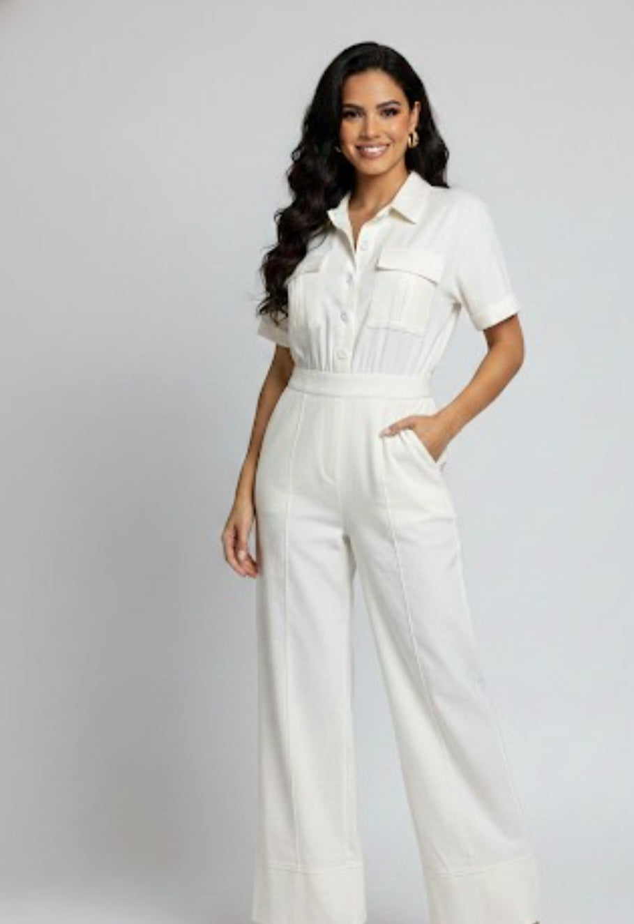 Woman wearing a white outfit on a plain background