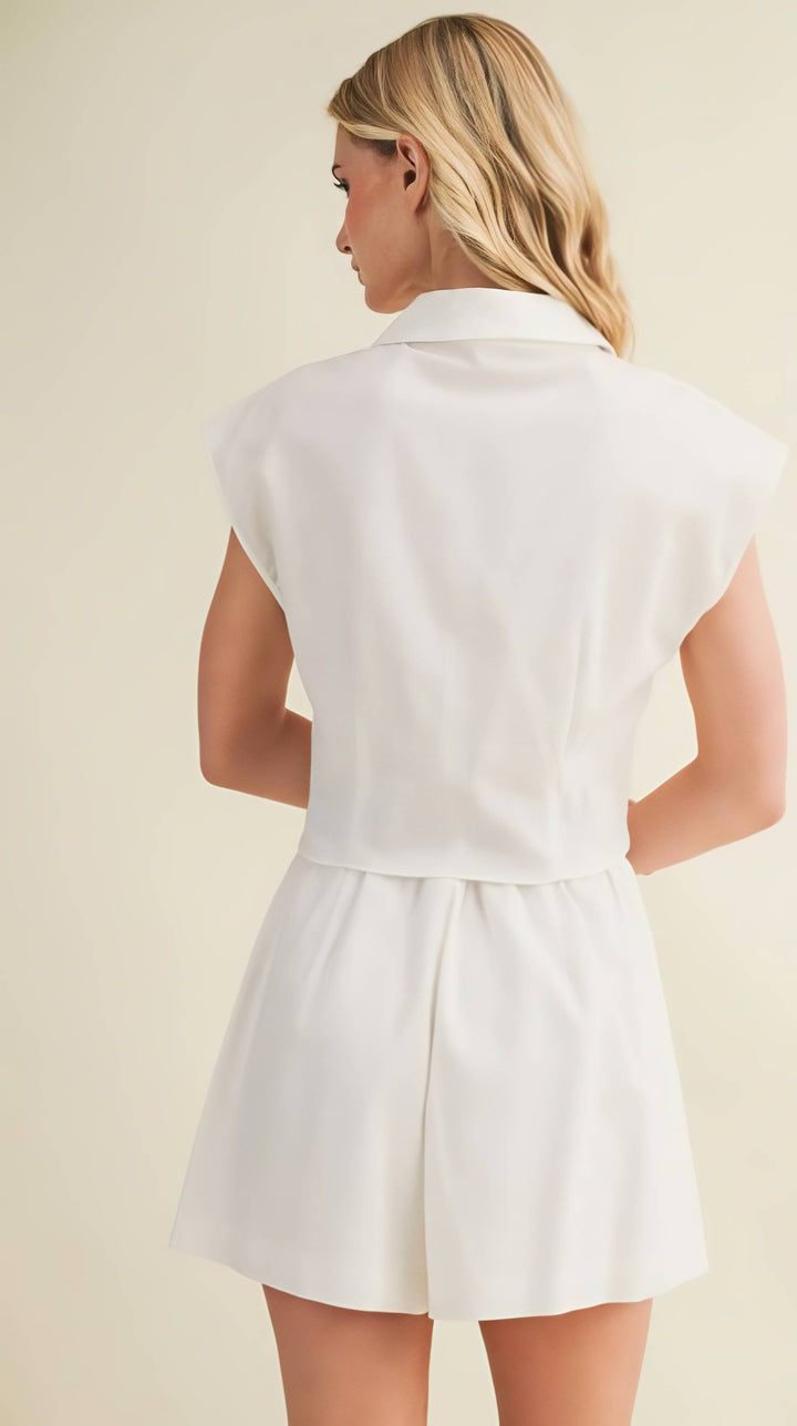 Woman wearing a white top against a beige background